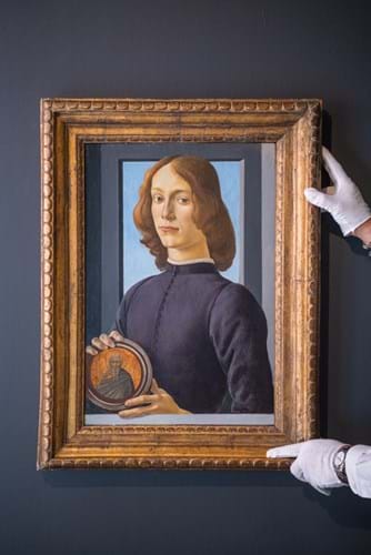 Young Man Holding a Roundel’ by Sandro Botticelli