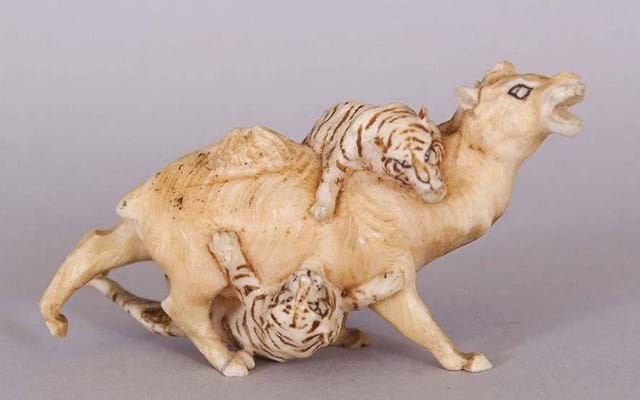 Ornament of two tigers attacking a camel