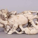 An ornament of a bear and a tiger attacking a boar