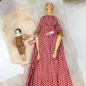 Wooden peg doll and a small porcelain-headed doll 