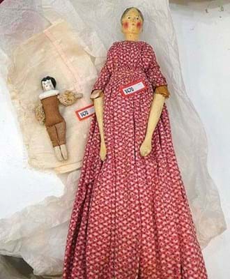 Wooden peg doll and a small porcelain-headed doll 
