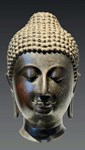 Sensitive carving shown on bronze head of Buddha