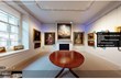 A virtual tour of a room containing paintings