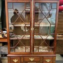 A glass-fronted bookcase or cabinet