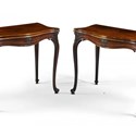 A pair of George III carved mahogany serpentine fold-over tables.