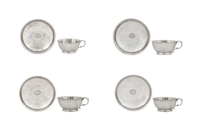 Silver teacups and saucers